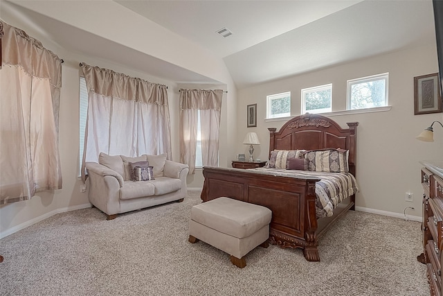 bedroom with light colored carpet and vaulted ceiling