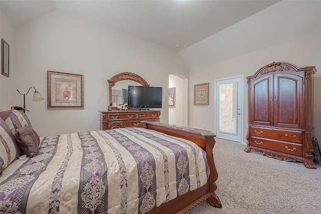 carpeted bedroom featuring access to exterior and vaulted ceiling