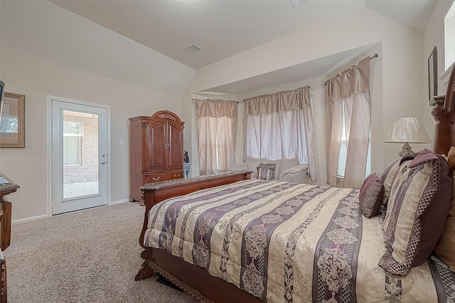 bedroom featuring multiple windows, lofted ceiling, light carpet, and access to exterior