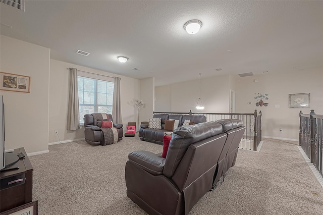 carpeted living room with a textured ceiling