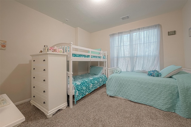 carpeted bedroom with a textured ceiling