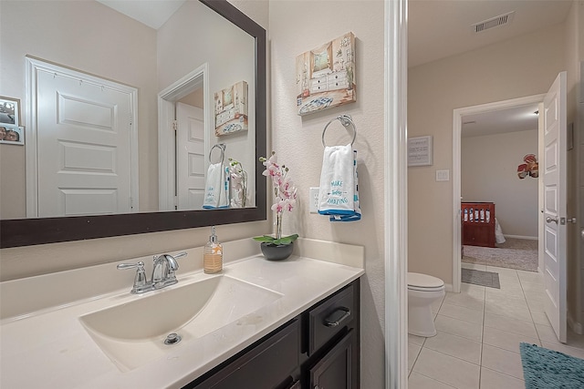 bathroom with vanity, tile patterned floors, and toilet