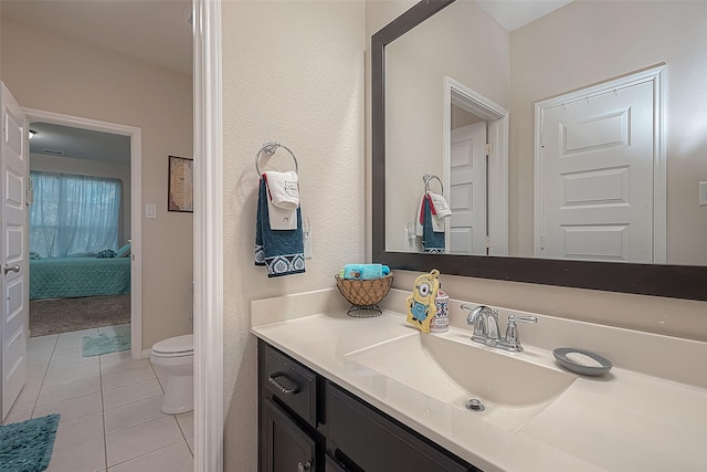 bathroom featuring vanity, tile patterned floors, and toilet