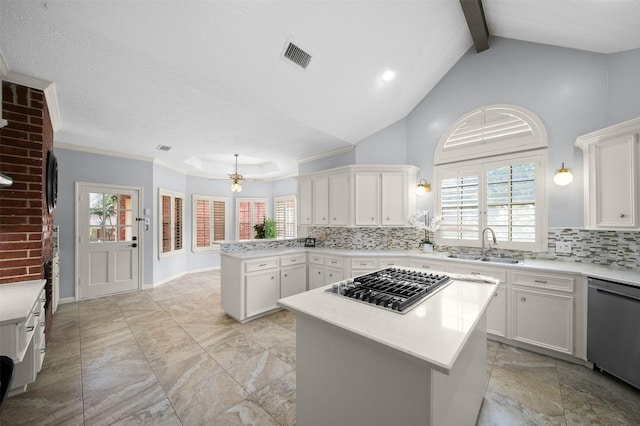 kitchen with stainless steel gas cooktop, sink, dishwasher, kitchen peninsula, and a kitchen island