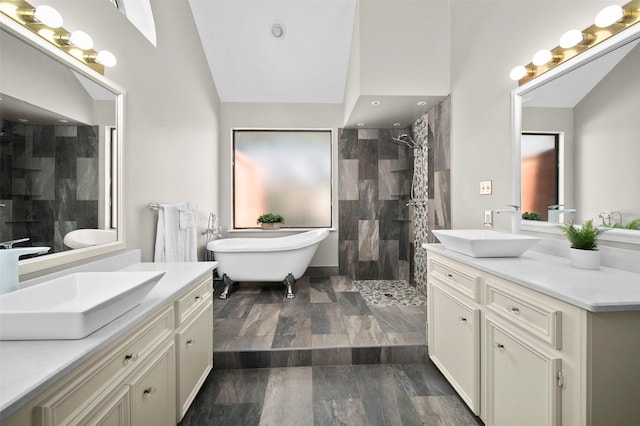 bathroom with vanity, separate shower and tub, and vaulted ceiling