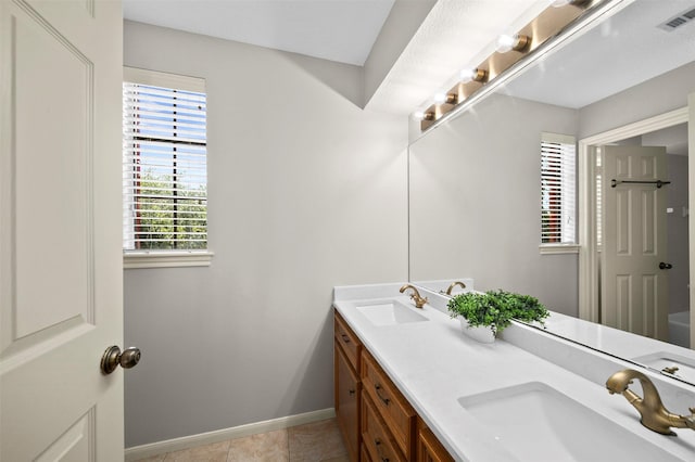 bathroom with tile patterned floors and vanity