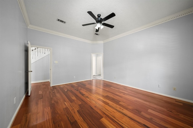 empty room featuring ceiling fan, dark wood-type flooring, ornamental molding, and a textured ceiling