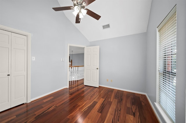 unfurnished bedroom with ceiling fan, high vaulted ceiling, and dark hardwood / wood-style flooring