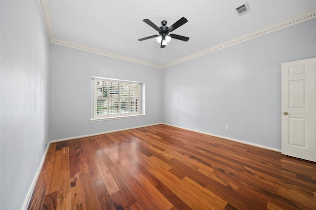 spare room featuring ceiling fan, ornamental molding, and dark hardwood / wood-style floors