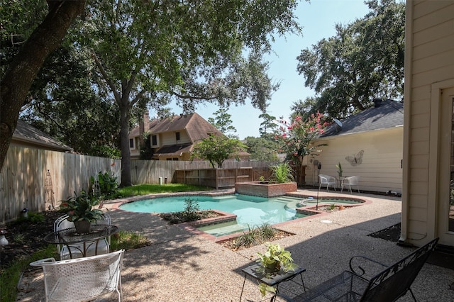 view of swimming pool featuring an in ground hot tub and a patio