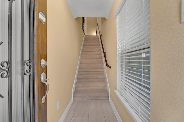 stairs featuring tile patterned flooring