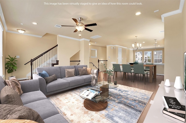 living room featuring ornamental molding, ceiling fan with notable chandelier, and light wood-type flooring