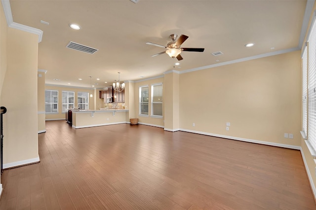 unfurnished living room with ornamental molding, dark hardwood / wood-style flooring, and ceiling fan with notable chandelier