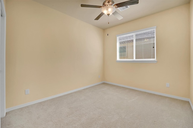 spare room featuring ceiling fan and light colored carpet