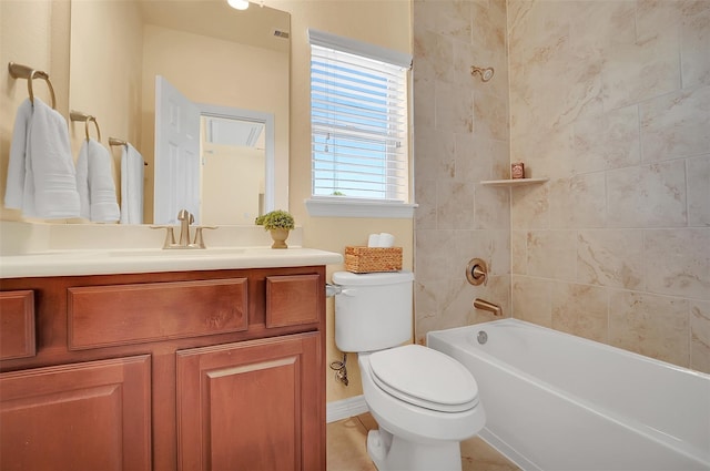 full bathroom featuring tiled shower / bath, vanity, and toilet