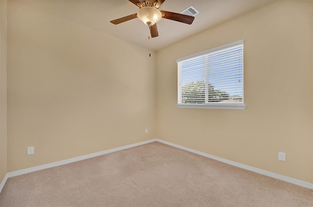 empty room featuring light colored carpet and ceiling fan