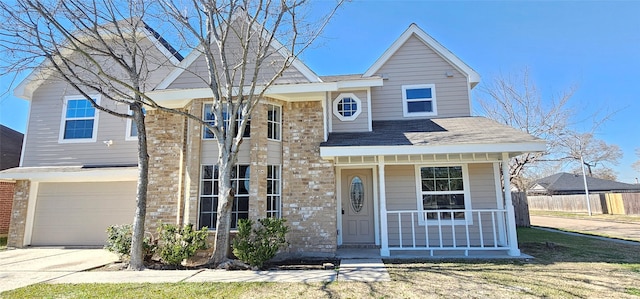 view of front of house with a garage, covered porch, and a front lawn