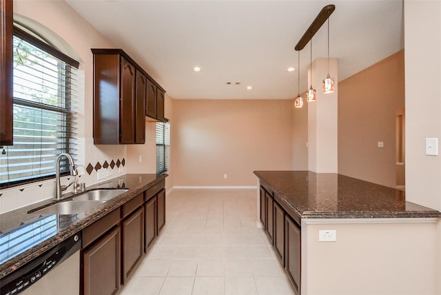 kitchen with sink, dark brown cabinets, hanging light fixtures, dark stone countertops, and dishwasher