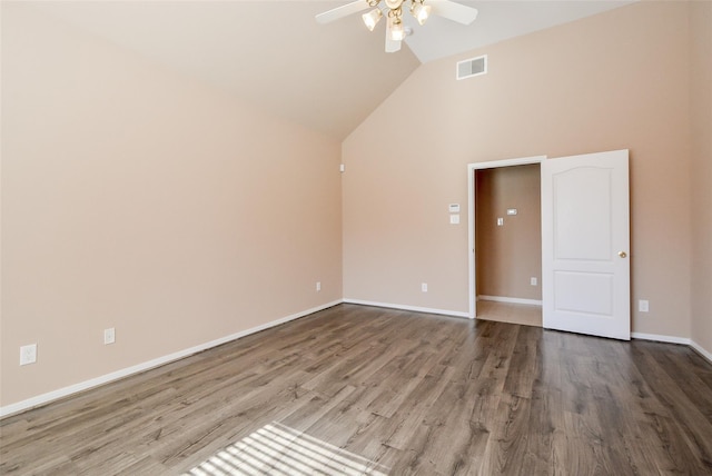 empty room with hardwood / wood-style flooring, vaulted ceiling, and ceiling fan