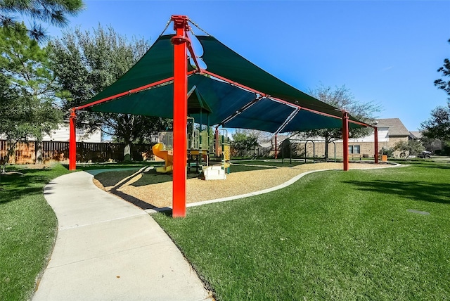 view of property's community with a playground and a lawn