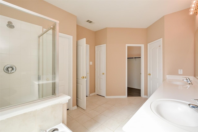 bathroom featuring vanity, tile patterned flooring, and a shower with door