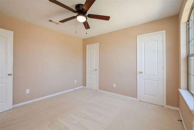 unfurnished bedroom with light colored carpet and ceiling fan