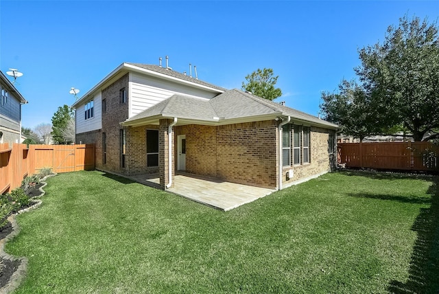 rear view of property featuring a lawn and a patio