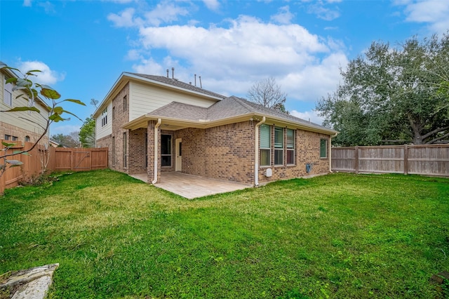 back of house featuring a lawn, a fenced backyard, a gate, a patio area, and brick siding