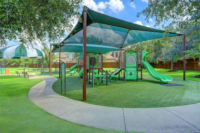 community play area with fence and a yard