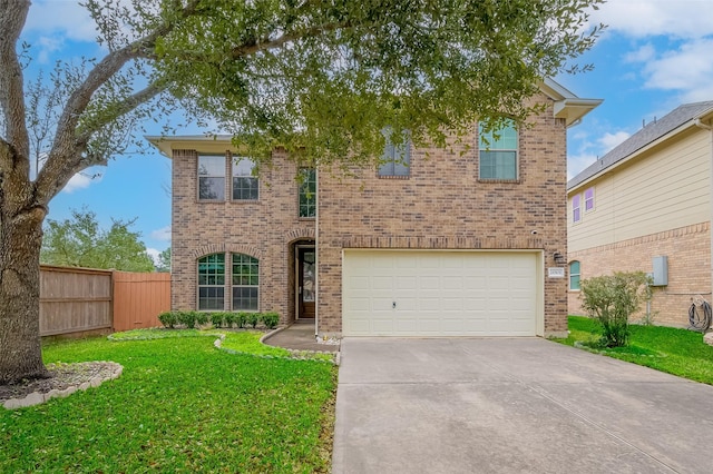 traditional-style home featuring brick siding, concrete driveway, an attached garage, a front yard, and fence