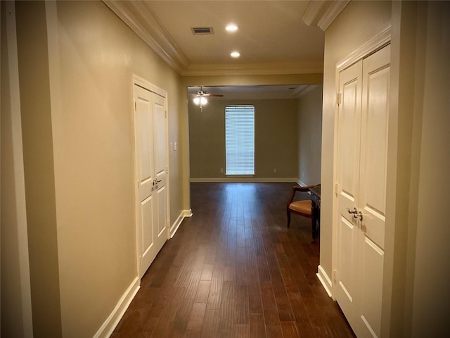 hall featuring crown molding and dark hardwood / wood-style flooring