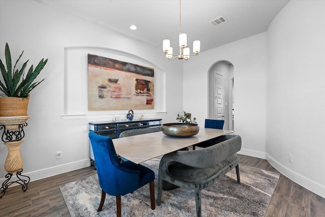 dining space featuring an inviting chandelier and dark hardwood / wood-style flooring