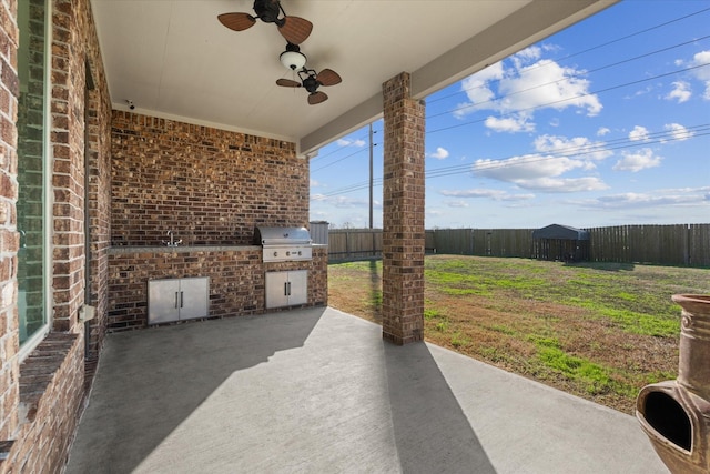 view of patio / terrace with an outdoor kitchen, area for grilling, and ceiling fan