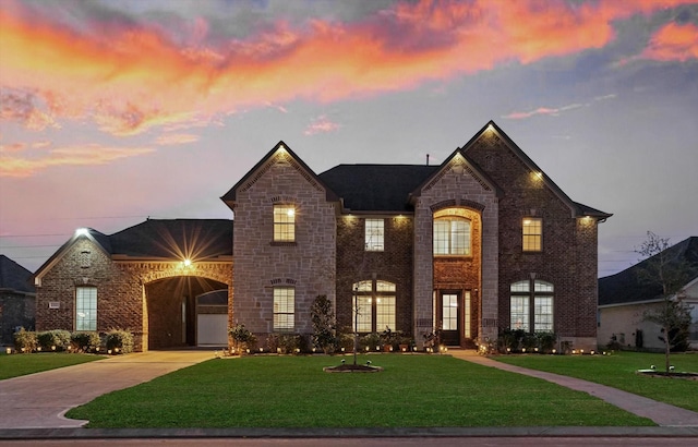 view of front of home featuring a garage and a lawn