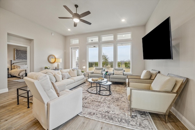 living room featuring ceiling fan and light hardwood / wood-style floors