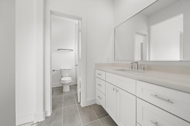 bathroom with vanity, tile patterned floors, and toilet