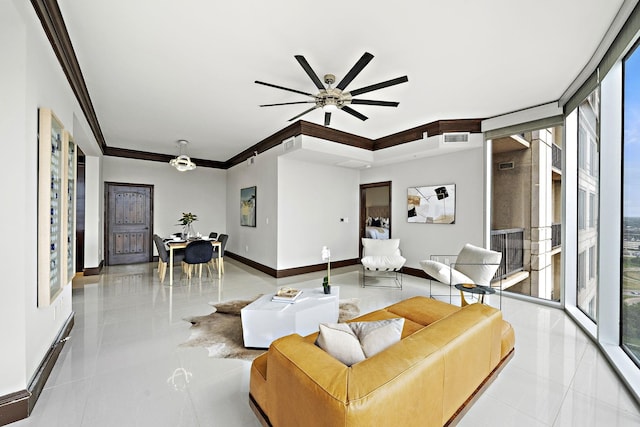 tiled living room featuring crown molding, ceiling fan, a healthy amount of sunlight, and floor to ceiling windows