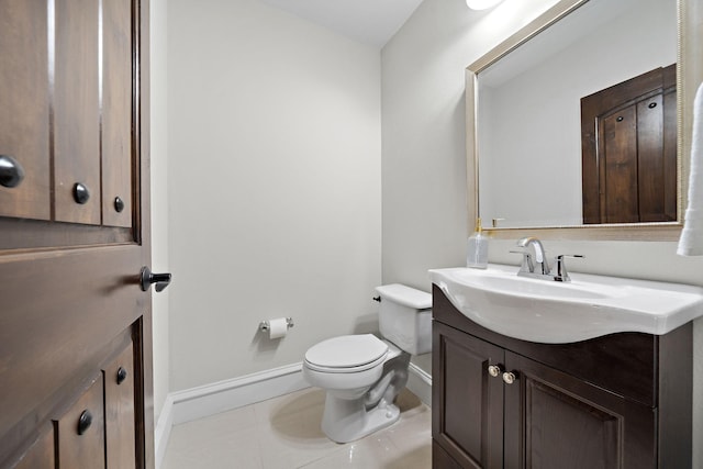 bathroom featuring tile patterned floors, vanity, and toilet