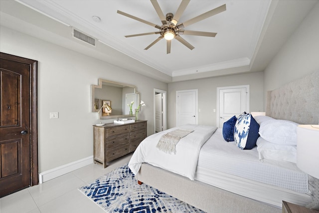 bedroom featuring crown molding, ceiling fan, a raised ceiling, and light tile patterned floors