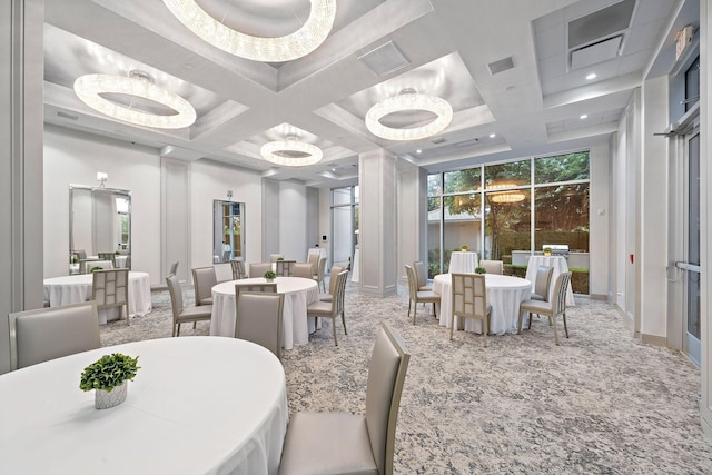 dining room featuring coffered ceiling, floor to ceiling windows, and a chandelier