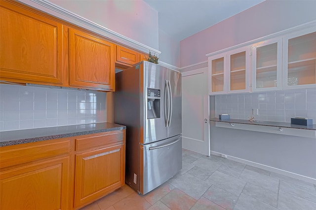 kitchen with stainless steel fridge and backsplash