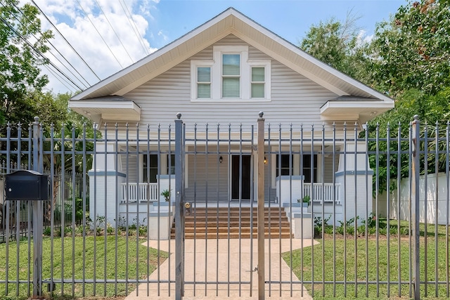 bungalow-style home featuring a porch and a front yard