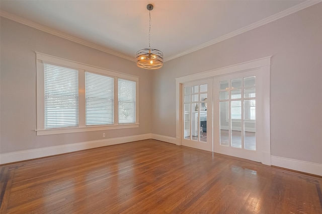 empty room with hardwood / wood-style floors, ornamental molding, french doors, and a healthy amount of sunlight