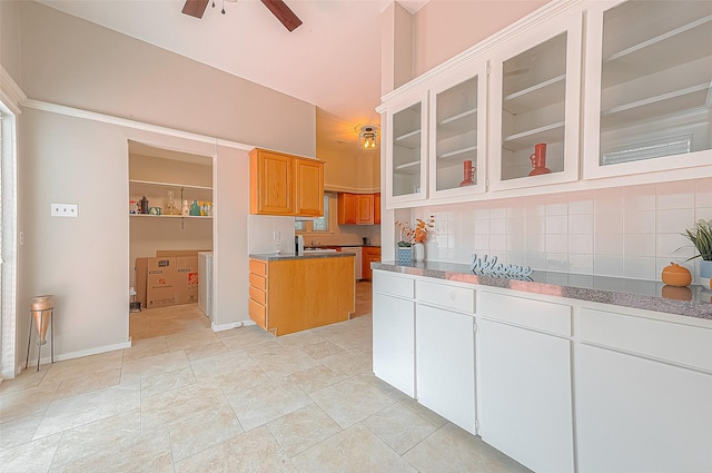 kitchen with ceiling fan and decorative backsplash