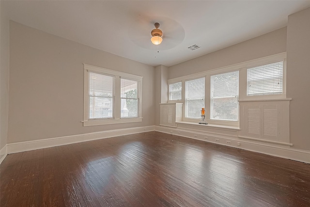 unfurnished room with dark wood-type flooring and ceiling fan