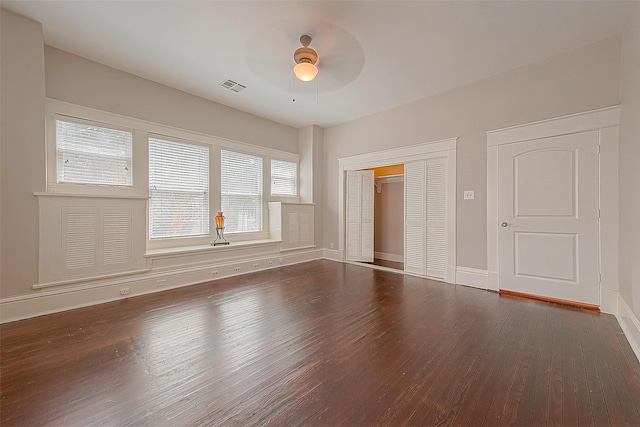 unfurnished room with ceiling fan and dark hardwood / wood-style floors