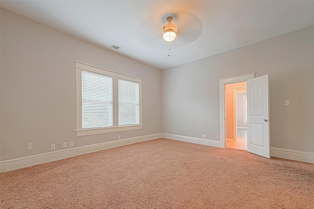 unfurnished room with ceiling fan and carpet