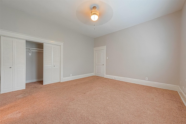 unfurnished bedroom featuring ceiling fan, a closet, and carpet