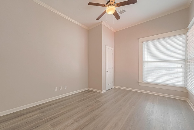 spare room with ornamental molding, ceiling fan, and light wood-type flooring