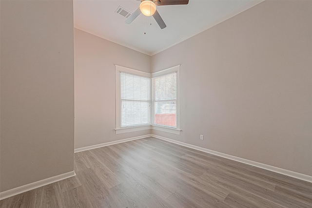 spare room with ceiling fan, ornamental molding, and light hardwood / wood-style flooring